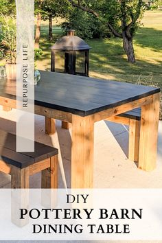 a wooden table sitting on top of a patio next to a forest filled with trees