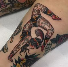 a woman's leg with tattoos on it and an image of a person doing yoga