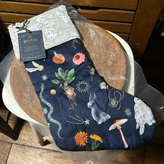 an old chair with some fabric on it and a tag attached to the seat cover