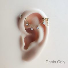 a pair of ear piercings on top of a white surface