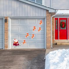 a garage door decorated with christmas decorations and santa claus riding a sleigh