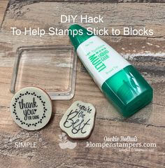 some kind of stamp that is sitting on top of a wooden table with the words, diy hack to help stamps stick to blocks