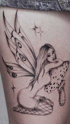 a woman's thigh with a tattoo design on the back of her leg and an image of a butterfly