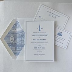 the wedding stationery is laid out on top of each other, including two envelopes