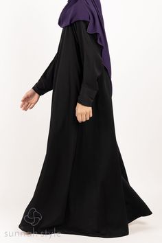 Our Girls Simplicity Umbrella Abaya is designed with a stunning princess cut for a modest and flowing fit. The abaya features a pleated neck with a diagonal zipper from the shoulder to the underarm and includes zippered side pockets for added convenience. The abaya is made of our premium crepe which is excellent quality, medium weight, and suitable for all seasons. The fabric has a smooth and slightly silky feel to it, allowing it to drape beautifully and making it perfect for everyday wear or special occasions. Modest Black Khimar, Long Black Abaya For Eid, Modest Black Abaya With Long Sleeves, Modest Black Long Sleeve Abaya, Modest Long Sleeve Black Abaya, Modest Black Long Sleeve Khimar, Modest Long Sleeve Black Khimar, Elegant Black Abaya With Modesty Panel, Black Long Abaya