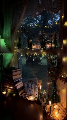 a room filled with lots of candles next to a window covered in books and lights