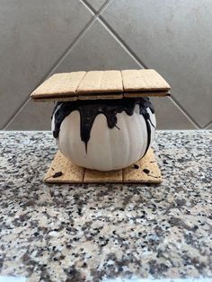 an ice cream sundae sitting on top of a counter next to a tile wall