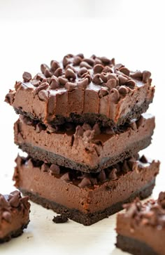 four pieces of chocolate cake stacked on top of each other