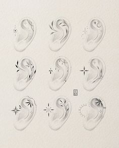 an image of water drops in the shape of ear shapes on white paper with black ink