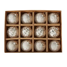 twelve silver christmas ornaments in a wooden box