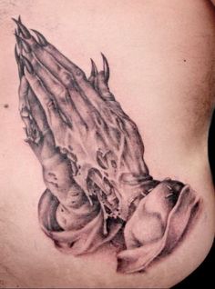 a man's chest with an image of hands coming out of the back tattoo