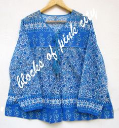 ITEM DESCRIPTION summer cotton blue floral screen printed women's tops and blouse - V neckline with tassels boho maxi blouse  Features : Long sleeve, V neck, Blouse Fabric: 100% Cotton Voile screen printed fabrics  Sleeve Length = 22 inch For more sizes & their measurement, please refer our below chart to understand the sizes variations available with us For your size requirement, please mention your size in seller note at the time of buying. Size measurement are for the dress, not for the body. SIZE MEASUREMENT  BUSTLENGTHSHOULDER XXS34 inch28 inch13.5 inch XS36 inch28 inch14 inch S38 inch28 inch14.5 inch M40 inch28 inch15 inch L42 inch28 inch16 inch XL44 inch28 inch16.5 inch 2XL46 inch28 inch17 inch 3XL48 inch28 inch18 inch   Company Return Policy: Please write for more information to my Blue Ring-spun Cotton Tops With Screen Print, Bohemian V-neck Blouse With Block Print, Blue Bohemian V-neck Blouse, Bohemian Blue Printed T-shirt, Light Blue Bohemian V-neck Blouse, Screen Printed Fabric, Boho Maxi, Cotton Voile, Blouse Fabric