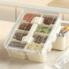 two plastic containers filled with food on top of a counter