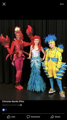 three children in costumes standing next to each other