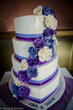 a wedding cake decorated with purple and white flowers