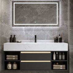 a bathroom vanity with a lighted mirror above it