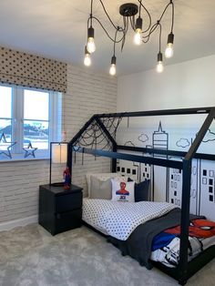 a bedroom with a bunk bed and some lights hanging from it's ceiling above the bed