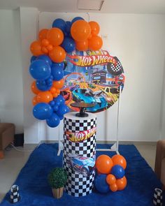 an assortment of balloons and decorations for a race car themed birthday party