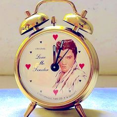 an old fashioned alarm clock with elvis presley on it's face and the words love me tender