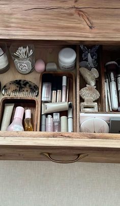 an open drawer filled with cosmetics and other items