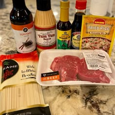 meat, spices and seasonings on a counter top