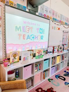 a classroom with lots of books and toys on the shelves next to a whiteboard