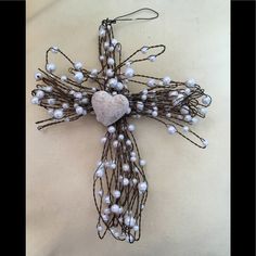 a cross made out of wire and pearls