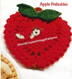 the crocheted apple is sitting next to some cookies