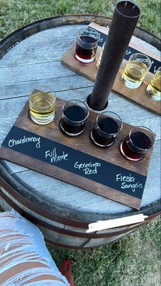 four glasses of wine are sitting on a barrel