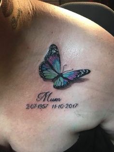 a woman's chest with a butterfly tattoo on it and the words mum written in cursive font