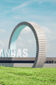 the entrance to kansas's westgate sign is shown in front of green grass