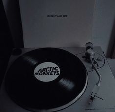 an arctic monkeys record player sitting on top of a table