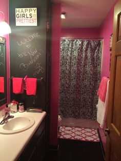 a bathroom decorated in pink and black