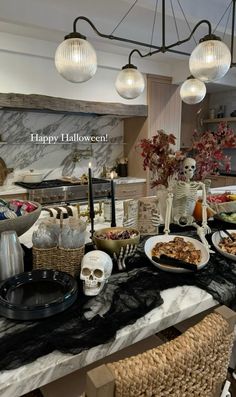 a table topped with lots of food and skeletons on it's sides in front of a counter