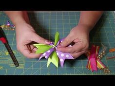 someone is making a paper flower on a cutting board