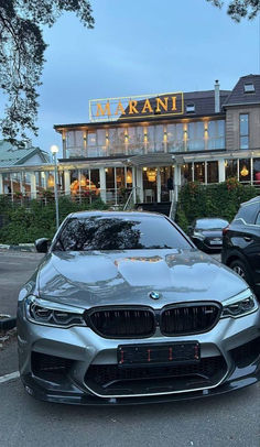 two cars parked in front of a restaurant