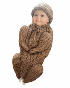 a baby doll wearing a knitted brown outfit