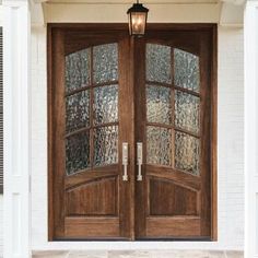 two wooden doors with glass on the outside