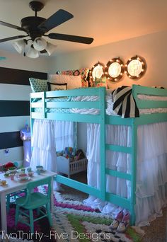 a child's bedroom with bunk beds, desk and ceiling fan in the corner