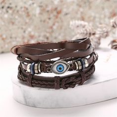 Infuse your day-to-day ensembles with bohemian-inspired flair when you wear this faux leather bracelet adorned with an evil eye pendant. 12.05'' L 13.46'' L 12.76'' L Sliding bead closure Silvertone copper / polyurethane / enamel Brown Evil Eye, Black Bracelet For Men, Heart Ankle Bracelet, Men Valentines, Bracelet Arm, Anklet Silver, Arm Bracelet, Labret Jewelry, Bracelet Elegant