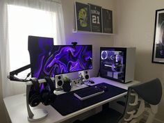 two computer monitors sitting on top of a white desk next to a keyboard and mouse