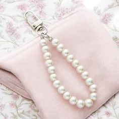 Add a touch of vintage elegance to your accessories with our Retro Pearl Keychain, designed for the modern woman with a love for timeless style. This versatile keychain features classic pearl beads, perfectly blending retro charm with the fashionable Coquette aesthetic. Whether you attach it to your car keys, handbag, backpack, or use it as a chic bracelet or phone charm, this keychain effortlessly elevates your look. Ideal for those who appreciate a blend of old-world sophistication and contemp Vintage Shoulder Bag With Pearl Handle For Everyday, Trendy Pink Bag With Pearl Handle, Feminine Pink Bag With Pearl Handle, Vintage White Bags With Pearl Handle, Luxury Bag With Pearl Handle, Rectangular Shape, Chic Bracelet, Backpack Charm, Phone Charm, Stylish Gifts