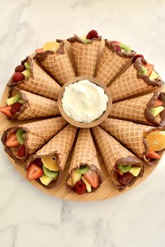 an ice cream sundae with strawberries, apples, and kiwis on it