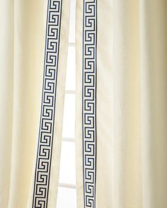 the curtains are open and ready to be hung in front of the window with an intricate greek motif