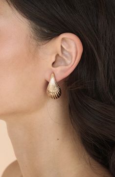 A ridged finish catches the light on scalloped teardrop earrings fashioned in a contemporary half-hoop silhouette. 32mm drop; 17mm width Post back Goldtone or silvertone plate Imported Elegant Shell-shaped Metal Earrings, Elegant Shell-shaped Earrings, Shell-shaped Metal Earrings, Metal Shell-shaped Earrings, Prom Inspiration, Concert Looks, Flip Flop Slippers, Clutch Pouch, Earrings In Gold