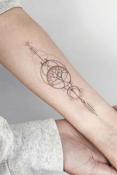 a woman's arm with a tattoo on it and an arrow in the middle