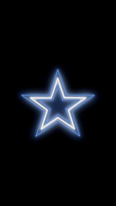 a blue neon star on a black background