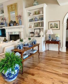 a living room filled with furniture and a fire place in the middle of a room