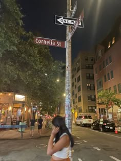 a woman walking down the street talking on her cell phone