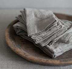 folded linen napkins on a wooden plate